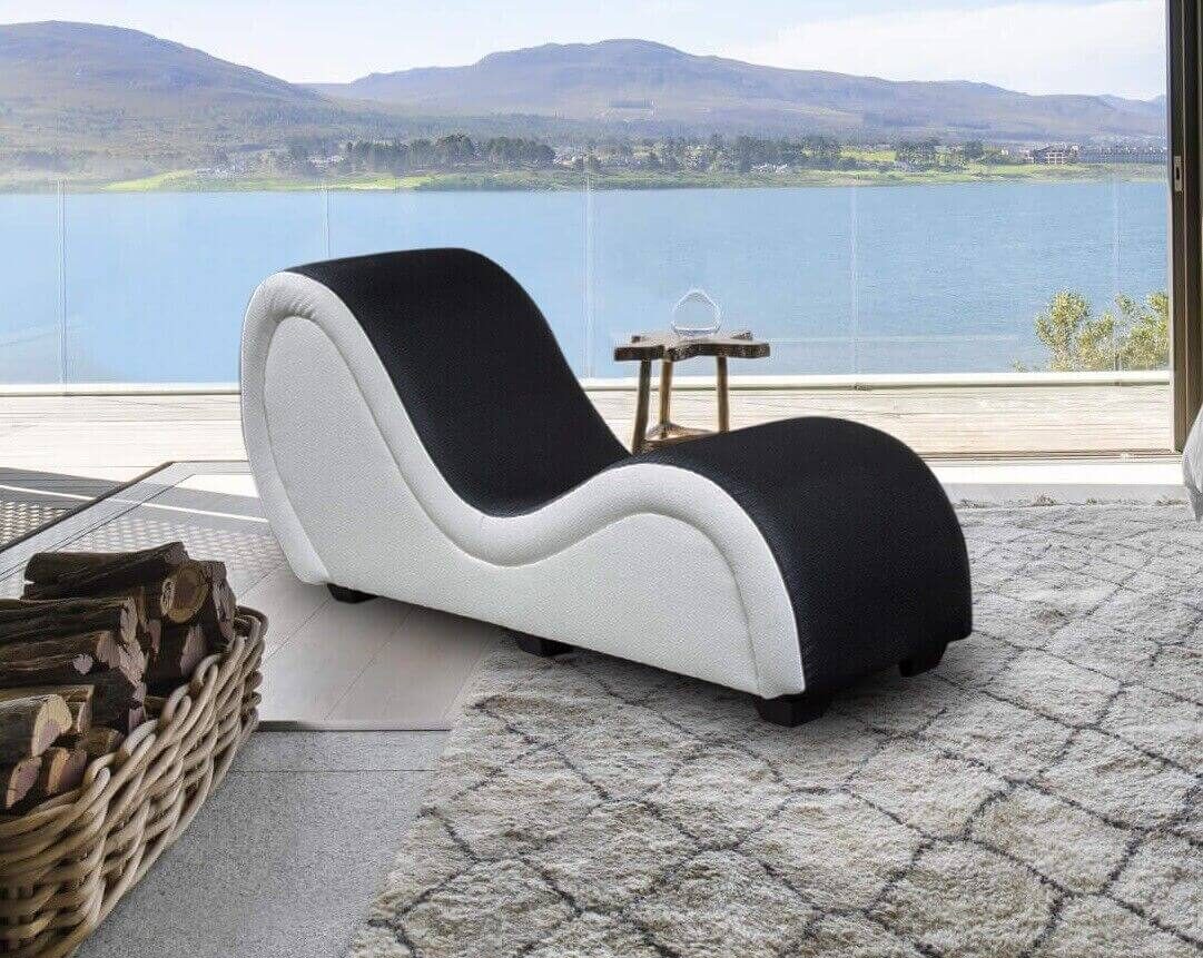 outdoor tantric chaise in front of a water and mountain